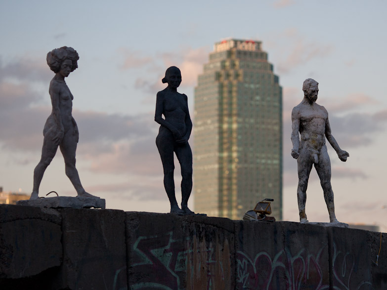 Nude sculptures on a graffiti wall in Greenpoint